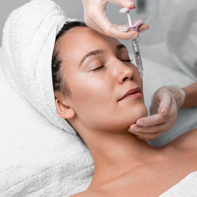 beautician-doing-filler-injection-female-client_23-2148875479