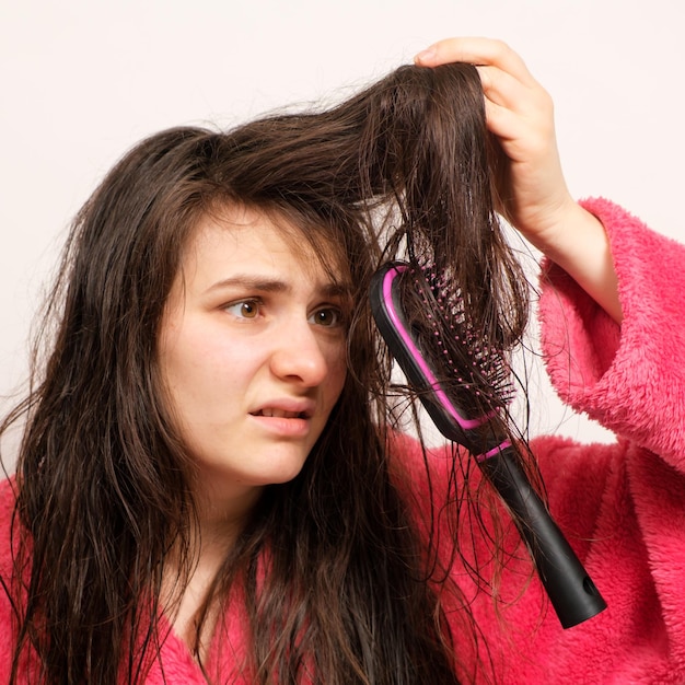 woman-with-wet-long-tangled-hair-tries-comb_528985-1364